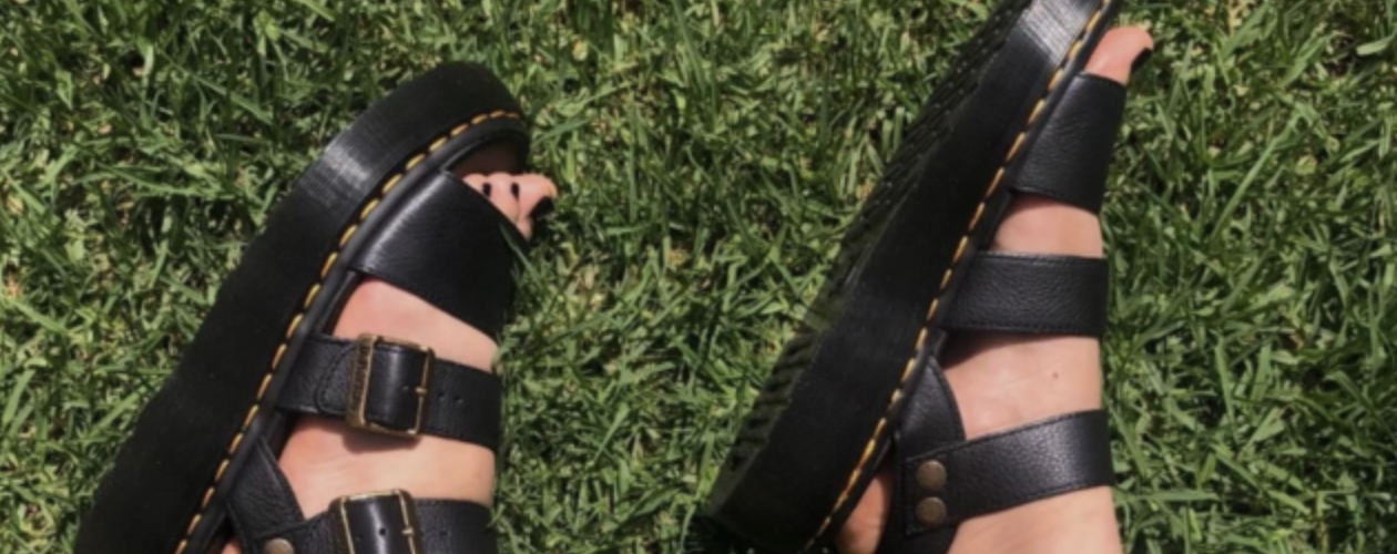 Dr. Martens sandals on the green field